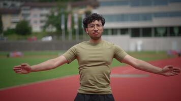 An athlete is actively performing various exercises out on the track field today video