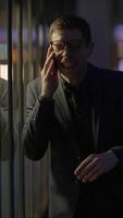 An Excited Man Engaging in a Phone Conversation While Enjoying the Nighttime Atmosphere video