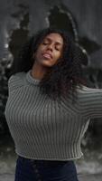 A graceful and elegant movement showcased in an urban setting while wearing a textured sweater video