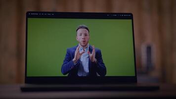 Professional Presenter on a Laptop While Using a Green Screen Background for Broadcasts video