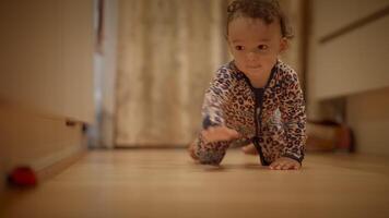 A Curious Toddler Joyfully Crawling in a Cozy Indoor Space Filled with Imagination and Fun video