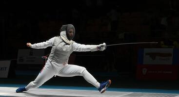 Dynamic fencing duel in action, en garde stance, sports photography for editorial use photo