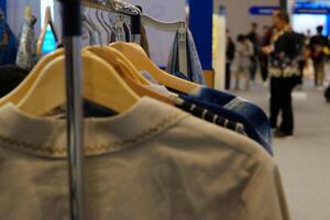 An array of Indonesian batik shirts and batik cloth hangs on the racks, displaying a variety of patterns and colors. photo