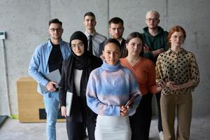 A diverse and determined team of business professionals stands confidently in an office, ready to tackle new business plans and challenges with a focus on success and growth photo