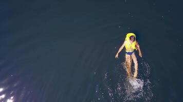 Boy having fun in river. Top down view of happy boy having fun, swimming in the river water video