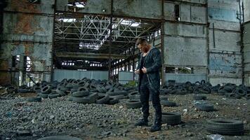 Man standing in ruined building. Young man posing in abandoned building video