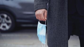 Surgical masks to prevent sickness. Close up of man with protective mask walking during pandemic COVID-19 video