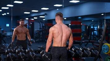 Exercise for the muscles biceps. Athletic man working out with dumbbell video