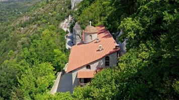 Monastery Building On Rock. Drone flight over mountain rock monastery video
