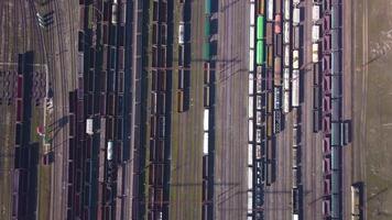 Aerial view of Railway sorting station and A lot of wagons at a railway. Drone flies over railway tracks. 4k quality video