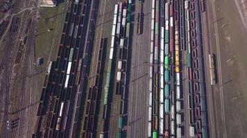 Aerial view of Railway sorting station and A lot of wagons at a railway. Drone flies over railway tracks. 4k quality video