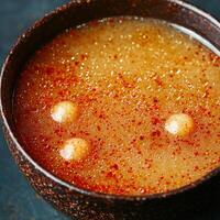 Spicy and savory soup with floating dumplings photo