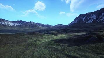 A breathtaking mountain range surrounded by lush green grass video