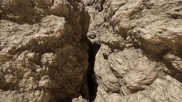A rock formation with a narrow opening in the middle video
