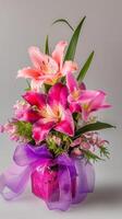 Lilies and orchids with ribbons flowing from wrapped base, wallpaper photo
