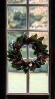 Magnolia leaves shaped into a wreath on window frame surface, wallpaper photo