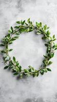 Myrtle branches woven into a ring on concrete wall background, photorealistic photo