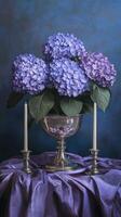 Hydrangeas in a silver bowl with tapers on a tablecloth surface, wallpaper art photo