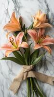 Lilies bound with a burlap ribbon on a marble table surface, wallpaper art photo