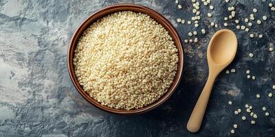 Close-up of quinoa arranged in a flat, wide-rimmed bowl with a simple utensil beside it, food photography photo