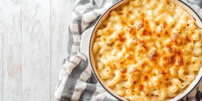 Close-up of mac and cheese in a ceramic baking dish, food setting photo