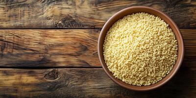 Close-up of couscous in a shallow ceramic bowl on a wooden table, meal photography photo