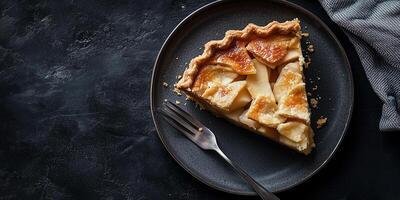 Slice of pie on a plate, showing baked apples and a flaky, intact crust, food photography photo