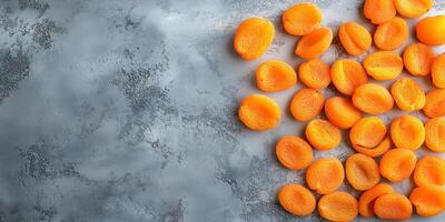 Top view of dried apricots scattered on a smooth surface, culinary photography photo