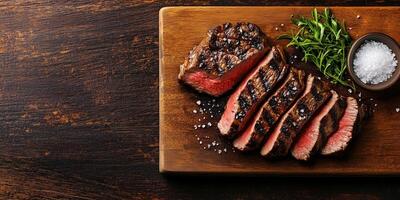 Grilled steak sliced on a cutting board with scattered coarse salt, culinary photography photo