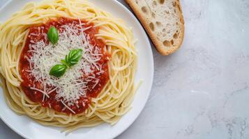 Spaghetti with tomato sauce and grated cheese on a plate, served with bread, culinary photography photo