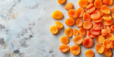 Top view of dried apricots scattered on a smooth surface, gastronomy photography photo
