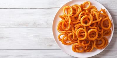 Curly fries on a white plate in circular pattern, gastronomy photography photo