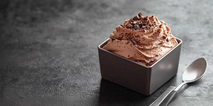 Mousse served in a square container with a uniform texture and no extra components, gastronomy photography photo