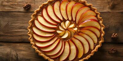 Pie featuring an open top, showing apple slices arranged in a circular pattern, food setting photo