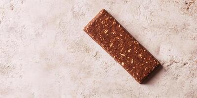 Protein bar on a flat surface with a smooth appearance, food setting photo