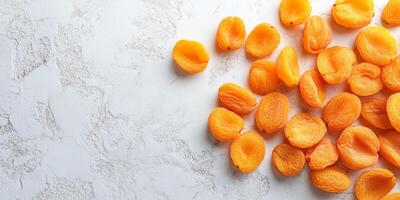 Top view of dried apricots scattered on a smooth surface, meal photography photo