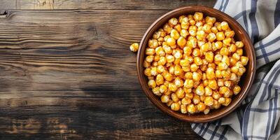 Caramel corn in a serving dish, with individual kernels clearly coated, food setting photo