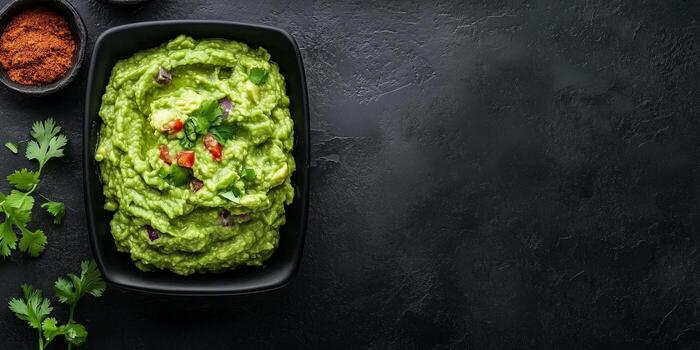Guacamole in a rectangular container, even texture, food setting photo