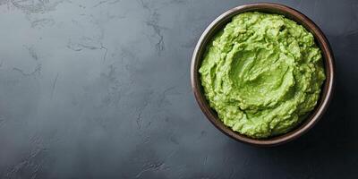 Guacamole in a round bowl, no toppings, smooth surface, meal photography photo