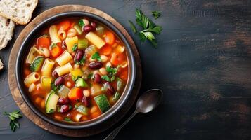 Minestrone soup in a shallow dish with vegetables, pasta, beans, and broth, meal photography photo