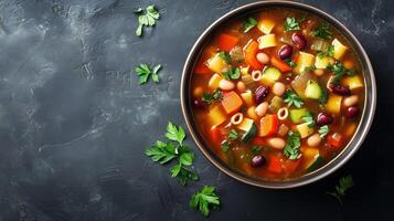 Minestrone soup in a round bowl with visible vegetables, pasta, and beans, food setting photo