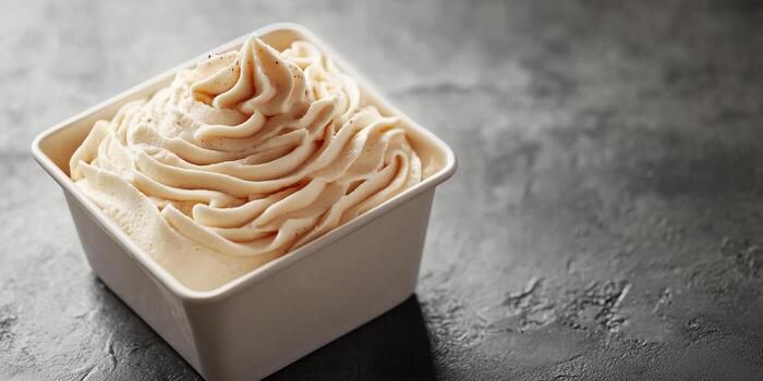 Mousse served in a square container with a uniform texture and no extra components, meal photography photo