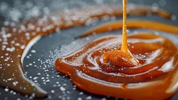 Close-up view of caramel sauce being drizzled onto a flat surface, food photography photo