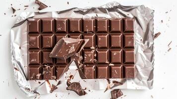 Filled chocolate bar with foil partially removed, exposing filling in the broken sections, culinary photography photo