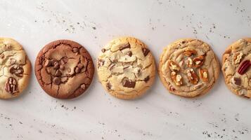 Five specialty cookies neatly aligned in a row on a light-colored table, food photography photo