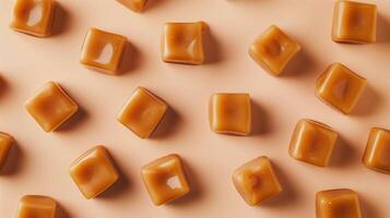 Cluster of caramel candies spread out on a neutral background, showcasing uniformity in shape and color, gastronomy photography photo