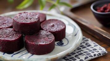 Set of red bean cakes with consistent shape and color on a dish, gastronomy photography photo