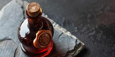 Craft distillery bottle with wax seal, on a polished stone surface, gastronomy photography photo