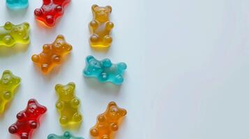 Gummy bears in multiple colors arranged loosely on a white surface, gastronomy photography photo