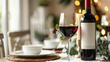 Bottle of red wine with a filled glass set near a cluster of grapes and leaves, food setting photo